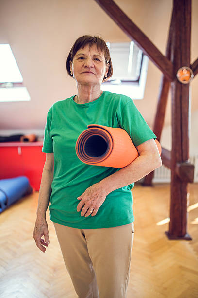 istock Old woman with exercise mat looking at the camera. 478945946