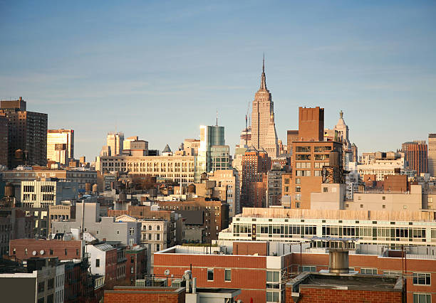 View of Empire State Building and rooftops in Manhattan, New York City, NY, USA.
