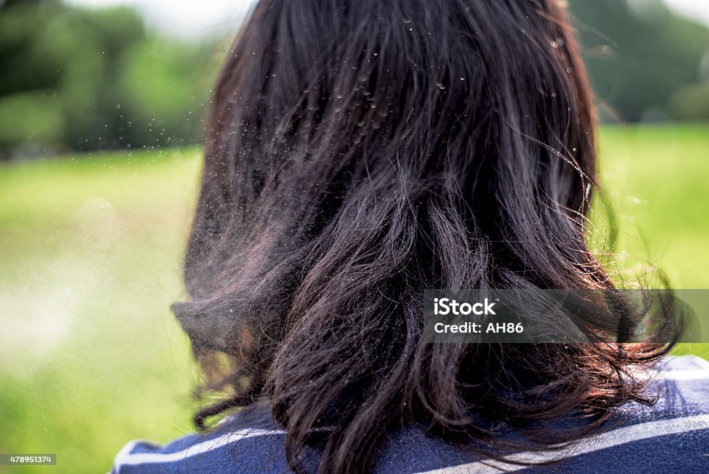 Splashing water on black hair of asian girl. Splashing water on black hair of japanese girl. 2015 Stock Photo