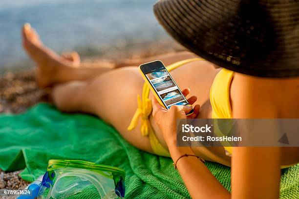 Woman Using Mobile Phone On The Beach Stock Photo - Download Image Now - Smart Phone, Beach, Computer Monitor