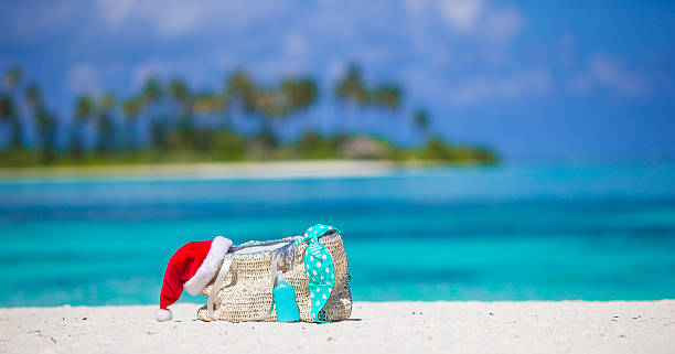 istock Beach accessories with Santa Hat on white tropical beach 478951634