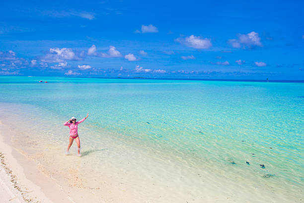 istock Beautiful woman relaxing at white sand tropical beach 478952096