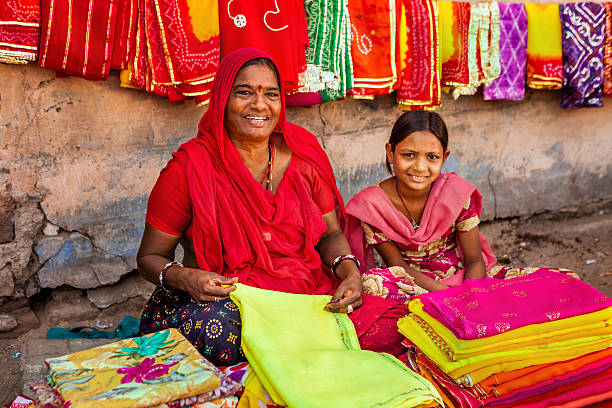 istock Indian women selling colorful fabrics 478956350
