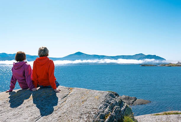 istock Two women enjoying view at fjord 478959131