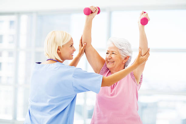 istock Therapist Assisting Senior Patient In Lifting Dumbbells 478961194