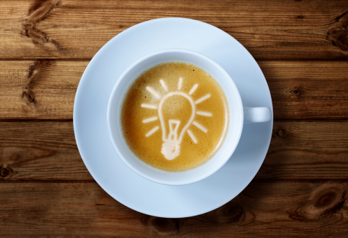 Coffee cup with light bulb idea in the froth concept for ideas, creativity and innovation