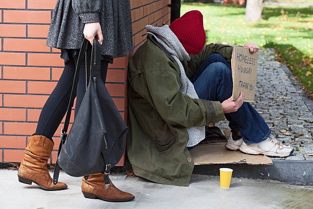 istock Woman passing by the homeless 478962043