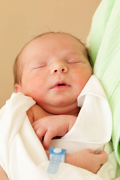 istock Cute sleeping newborn baby child on mother hands 478962885