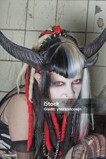 Scary Hungry Female Demon In Front Of Bloody White Wall Stock Photo - Download Image Now