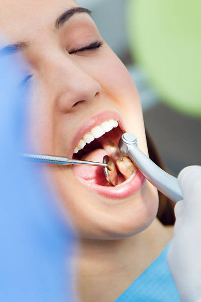 istock Cute young woman at the dentist. Mouth checkup 478969921