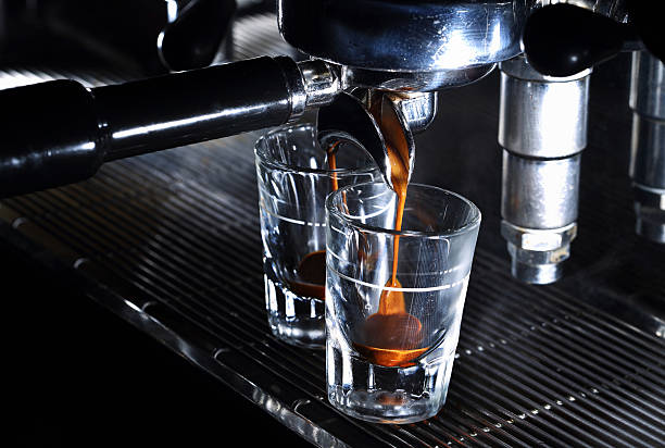 istock Professional espresso machine. Coffee pouring into shot glasses 478971086