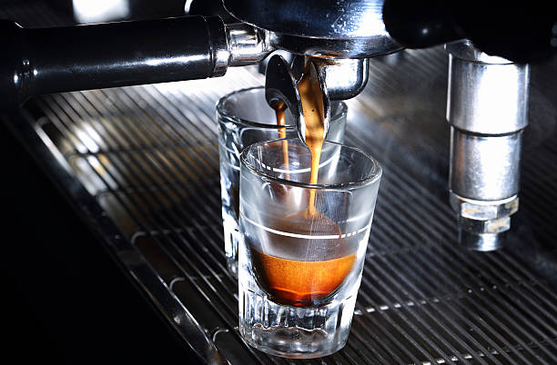 istock Espresso machine brewing a coffee. Coffee pouring into shot glasses 478971092