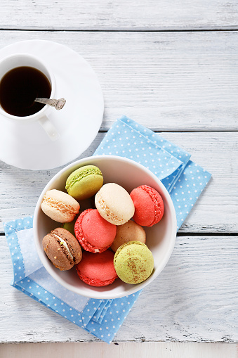 Macaroon with coffee on the boards, wooden background