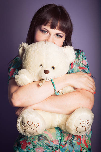 istock beautiful middle-aged woman hugging a teddy bear 478972442