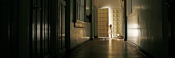 istock Girl at illuminated door 478973959
