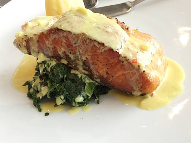 istock Salmon on spinach, topped with a cream sauce 478978480