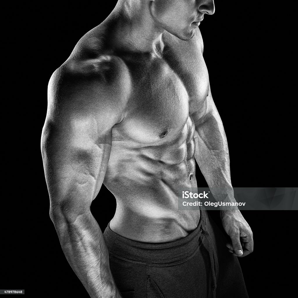 Fit young bodybuilder fitness male model posing Young athletic man torso showing six pack abs. Strong bodybuilder with six pack, perfect abs, shoulders, biceps, triceps and chest 2015 Stock Photo