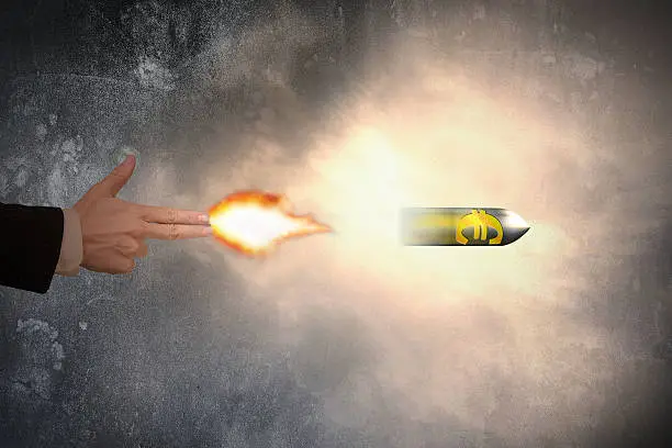Hand of gun gesture with firelight shooting the euro symbol bullet
