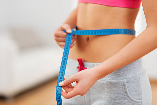istock Slim woman with measuring tape 478979185