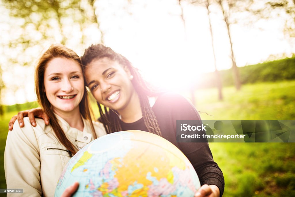 teenagers college student smiling with globe Global Communications Stock Photo