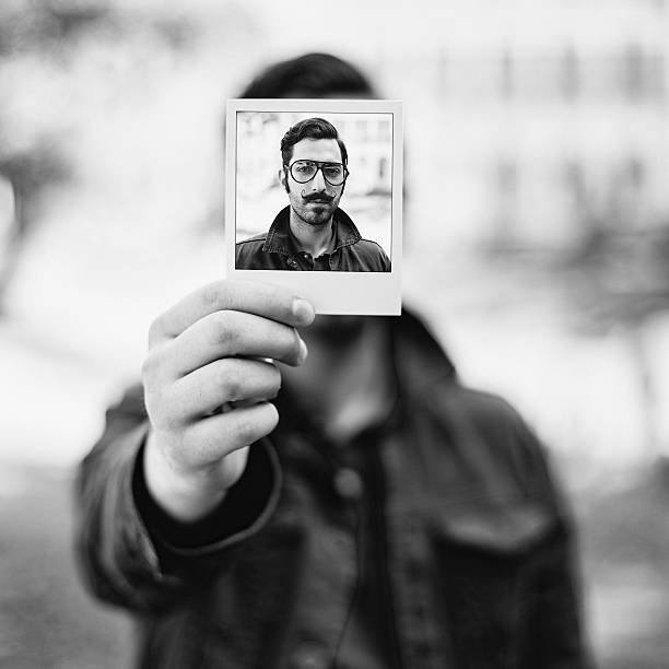 istock Man holding instant photo 478981952