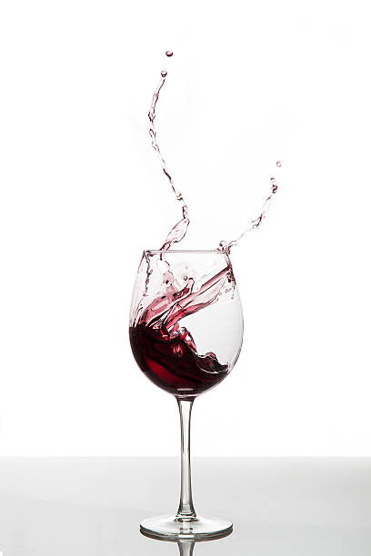 red wine splash stock photo