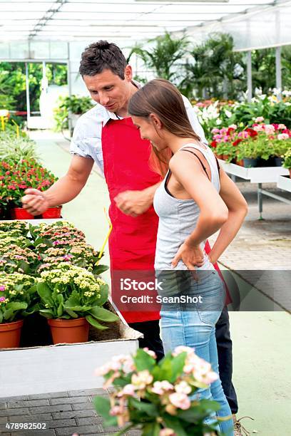 Clerk And Customer In A Garden Center Store Stock Photo - Download Image Now - 2015, Adults Only, Apron