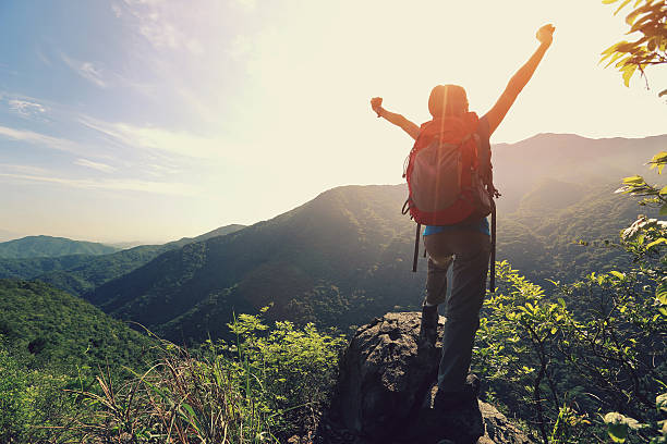 istock young woman hiker open arms moutain peak 478992060
