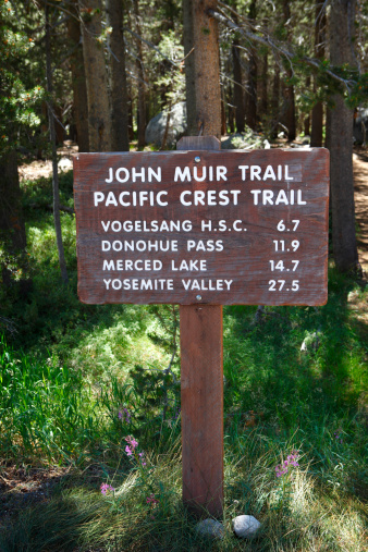 A trail marker for the John Muir Trail and the Pacific Crest Trail in Yosemite National Park.