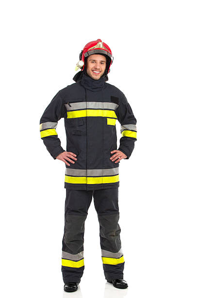 fröhlich fireman posieren. - isolated on white full length red protection stock-fotos und bilder