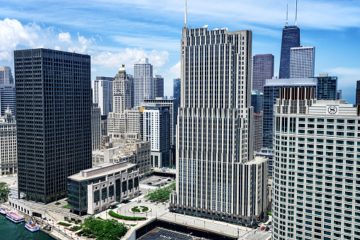 Chicago, USA - June 21, 2015: Downtown Chicago landmarks. Equitable Building, Gleacher Center, Intercontinental Hotel (Medinah Athletic Club), NBC Tower, John Hancock Building and the Sheraton Hotel and Towers. Aerial view of architecture besides the Chicago River in Streerville. Distant people.