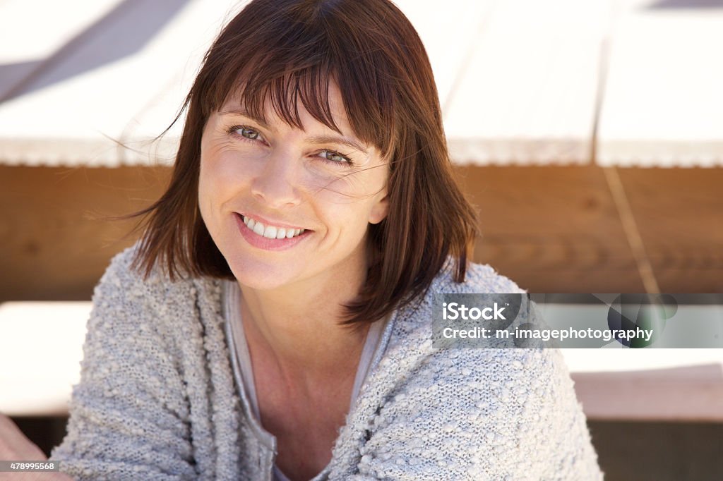 Healthy older woman smiling outside Close up portrait of a healthy older woman smiling outside Women Stock Photo