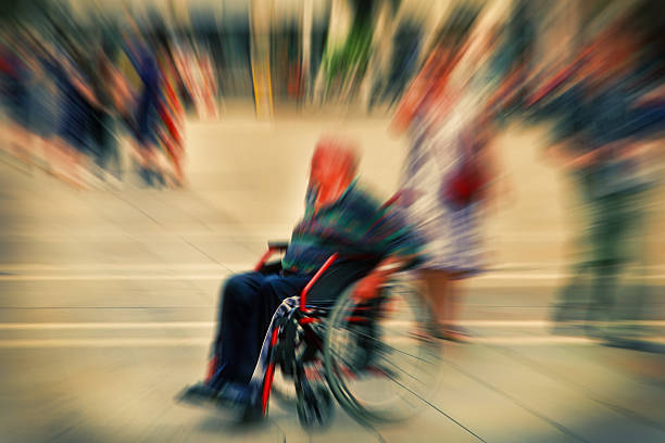 Abstract background. A disabled person in a wheelchair on a city street. Radial zoom blur effect defocusing filter applied, with vintage instagram look.