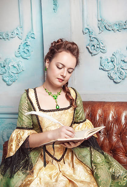 istock Beautiful woman in medieval dress writing diary 478999219