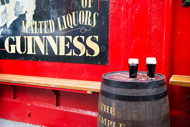 Pints of Guinnesss at Temple Bar Dublin Dublin, Ireland - May 31, 2013: Pints of Guinness beer sit on a barrel outside Temple Bar, established in 1840 and located in the Temple Bar district of Dublin. guinness photos stock pictures, royalty-free photos & images