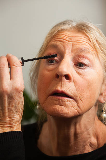 istock Good looking senior woman doing make-up. 479001483