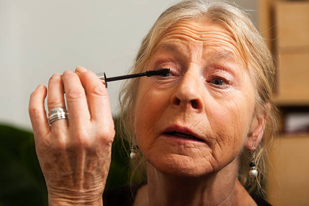 istock Good looking senior woman doing make-up. 479001555