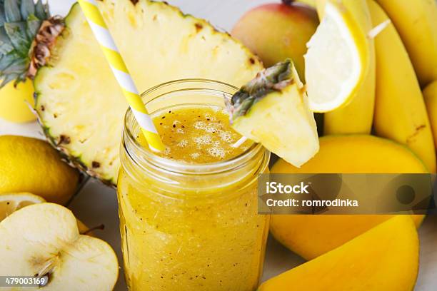 Fresh Organic Yellow Smoothie With Banana Apple Mango Pineapple Stock Photo - Download Image Now
