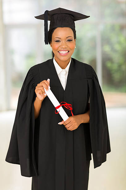 istock young black college graduate holding certificate 479009514