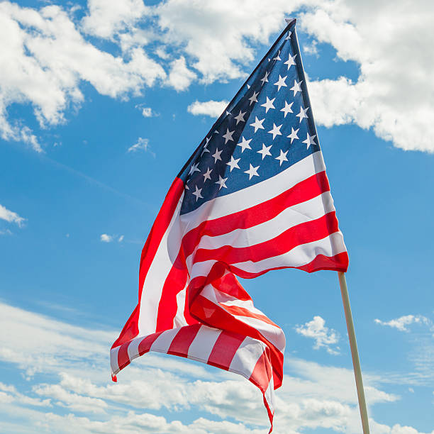 istock USA flag and clouds - close up outdoors shot 479009792
