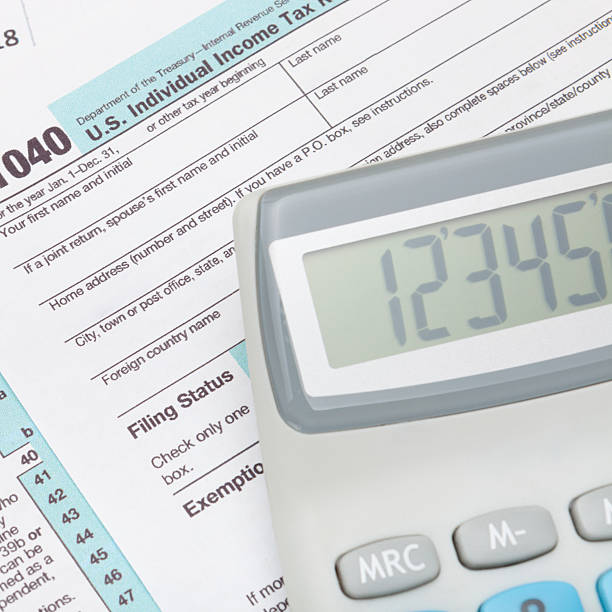 istock Calculator over US 1040 Tax Form - close up 479013272