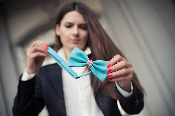 The girl with bow tie in front of old looking widow The girl with bow tieThe girl fixing bow tie