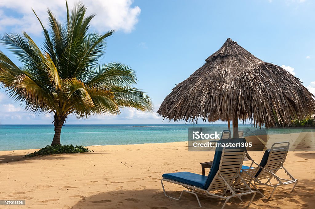 Sunbed and umbrella on a tropical beach Sunbed and umbrella on a beautiful tropical beach 2015 Stock Photo