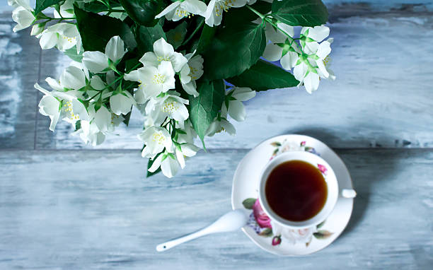 istock Jasmine flowers in a pot and cup of tea, rustic 479023524