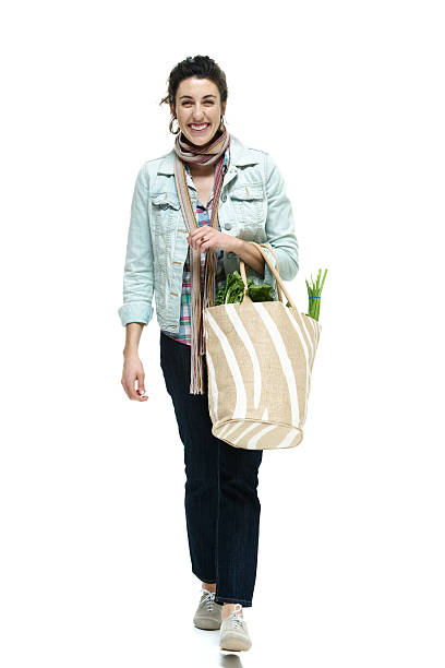 istock Cheerful woman walking with vegetable bag 479030217