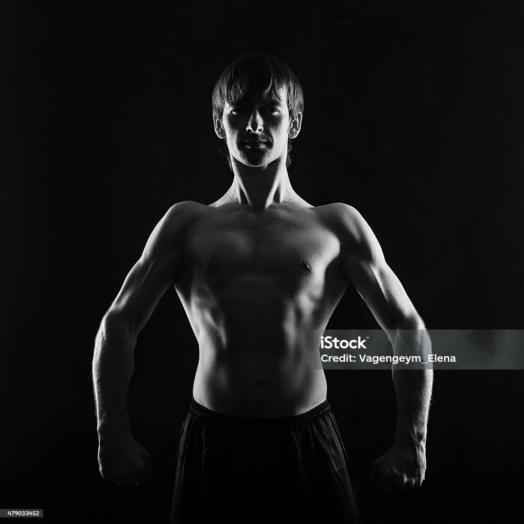 Athlete fighter frontal photo Male fighter frontal photo. Low key. The concept of male power. 2015 Stock Photo