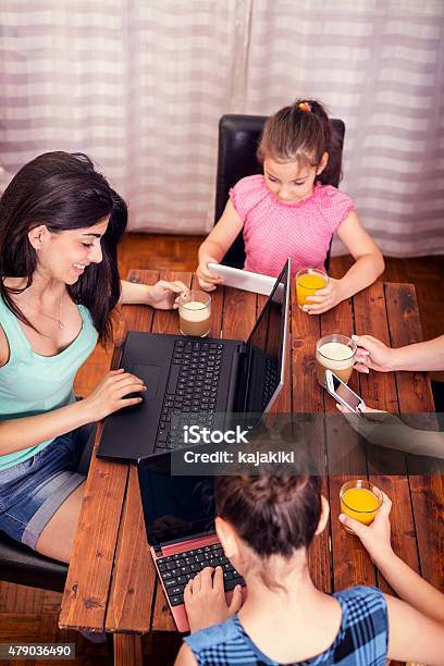 Familia Joven Usando Una Variedad De Dispositivos Digitales Cngltec168 Foto de stock y más banco de imágenes de 10-11 años