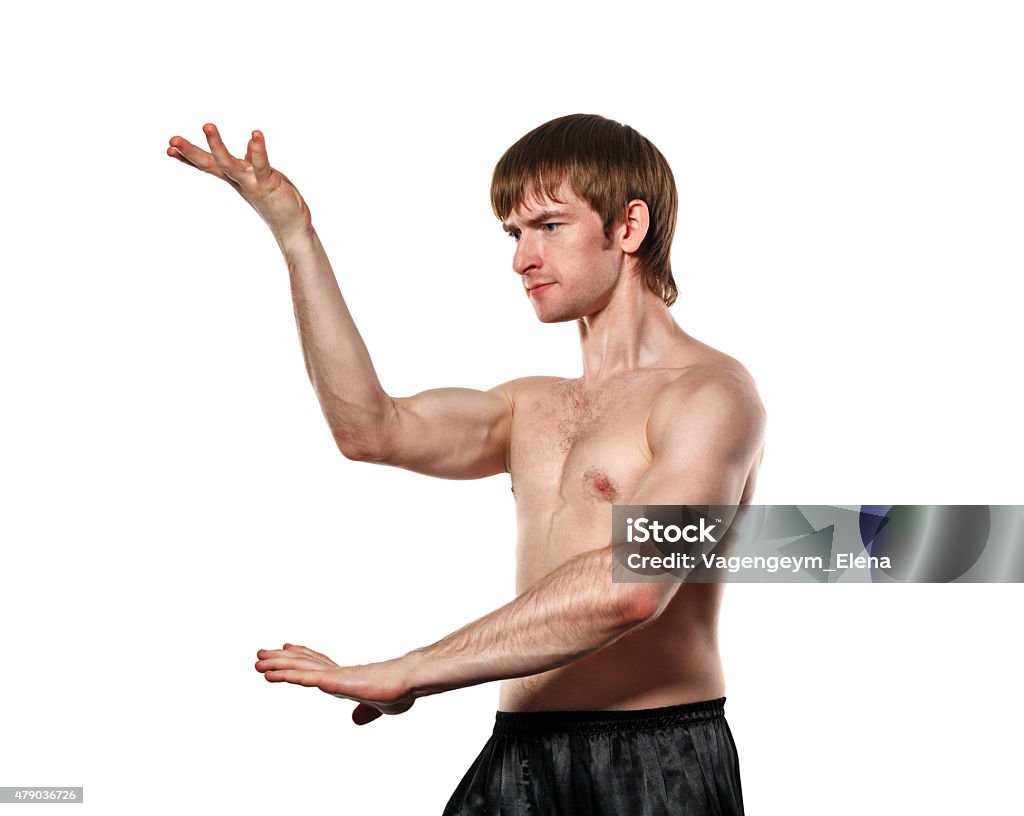 Fighter Kung Fu The man trains kata kung fu. Isolated on white background. Healthy lifestyle concept. 2015 Stock Photo