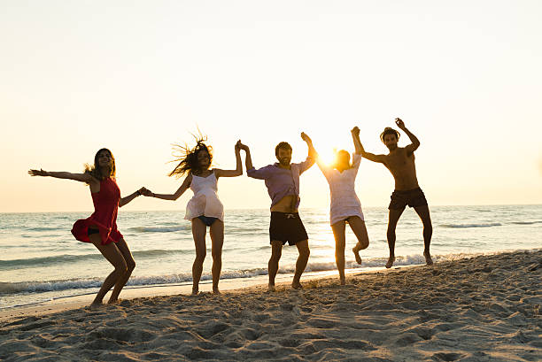 istock Five happy friends jumping on the beach for summer 479039224
