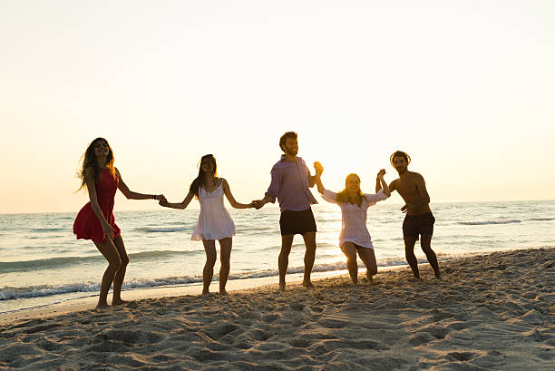 istock Five happy friends jumping on the beach for summer 479039234